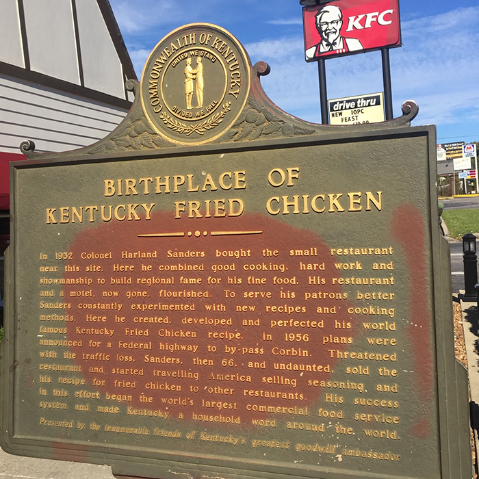 Informational plaque reading "Birthplace of Kentucky Fried Chicken"